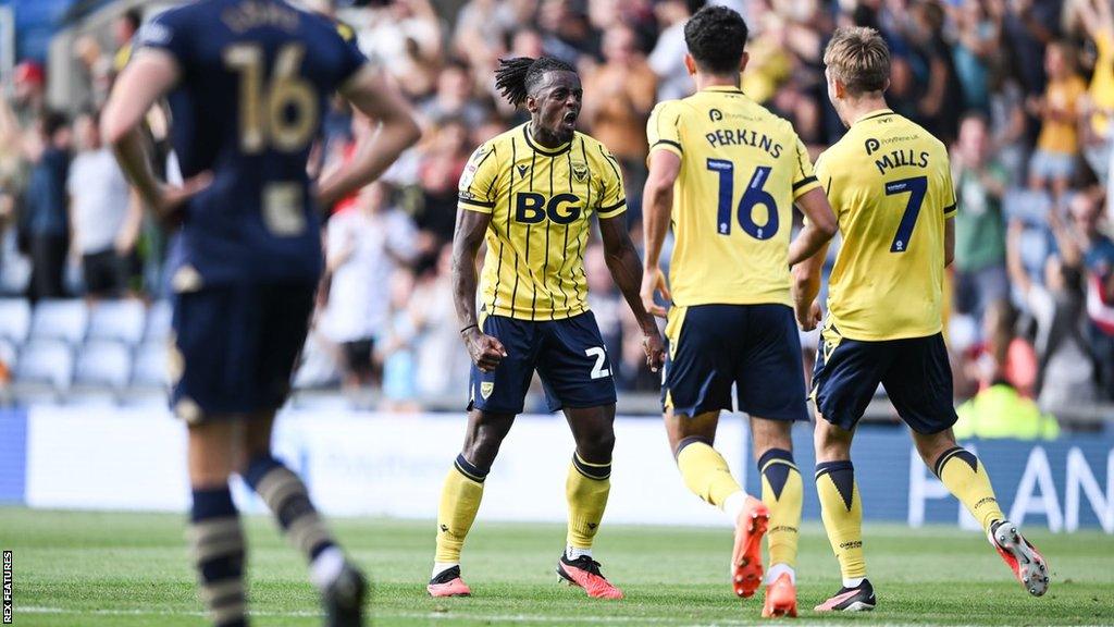 Oxford United players celebrate scoring against Port Vale in League One.