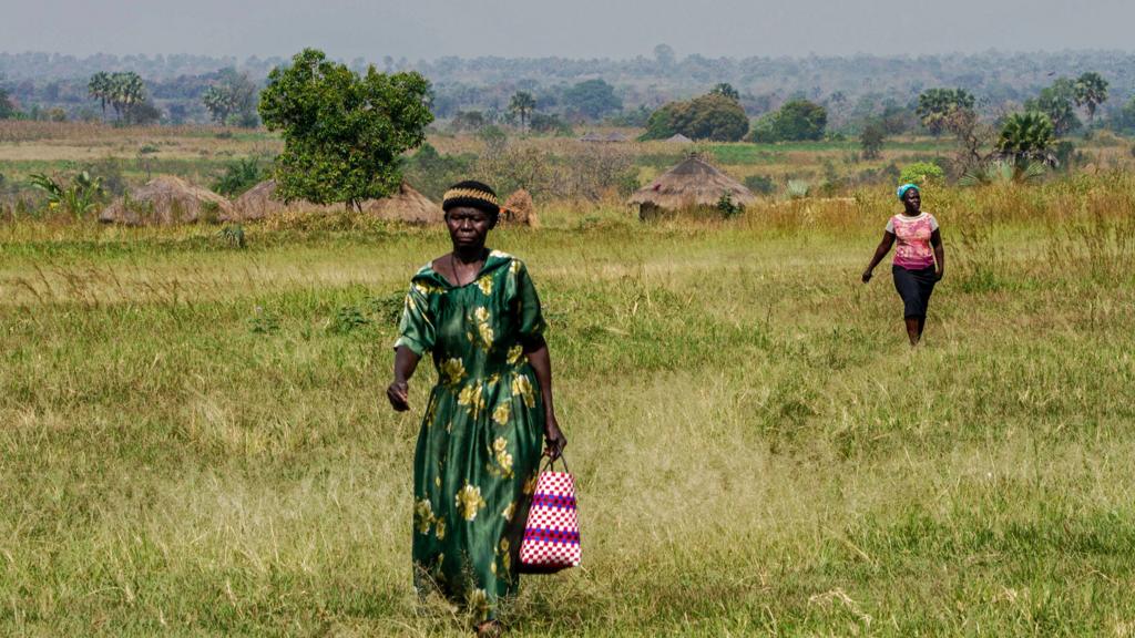 People in Gulu, northern Uganda, walking through a field