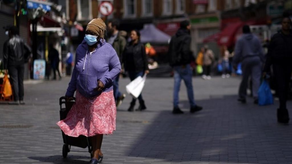 A member of the public passes through Brixton Market London, Britain, 11 June 2020.