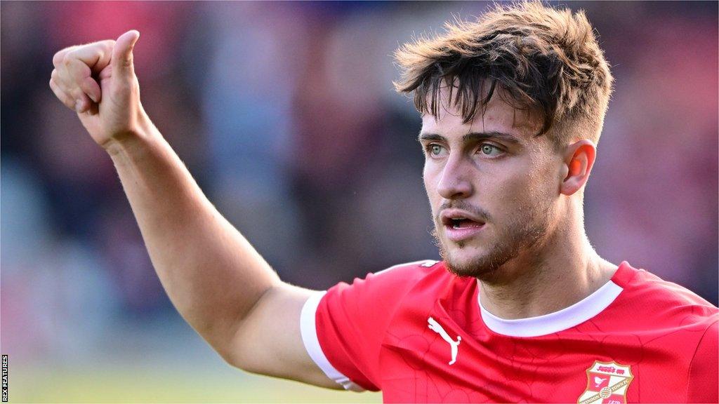 Jake Young gives a thumbs up during a Swindon game