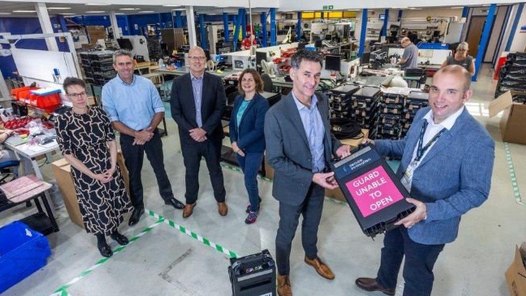 Councillor Louis Gardiner, far right, with Tony Westington, managing director of Secure Innovation. Pictured behind (left to right) are Secure Innovation's Lorraine Gunton, Jason Gibbs, Martin Pascoe, and Hazel Gosling