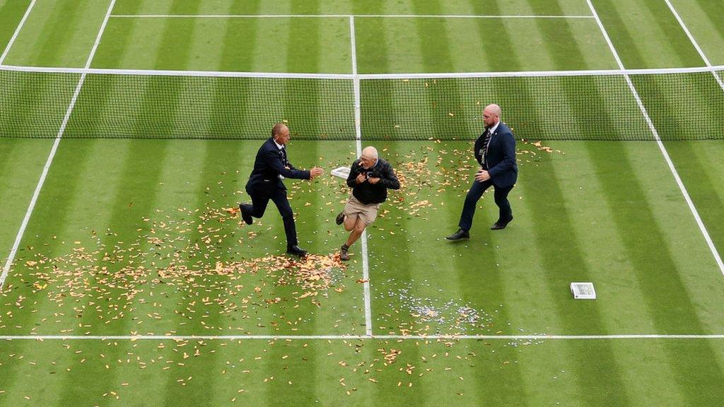 A Just Stop Oil protester runs onto the court at Wimbledon