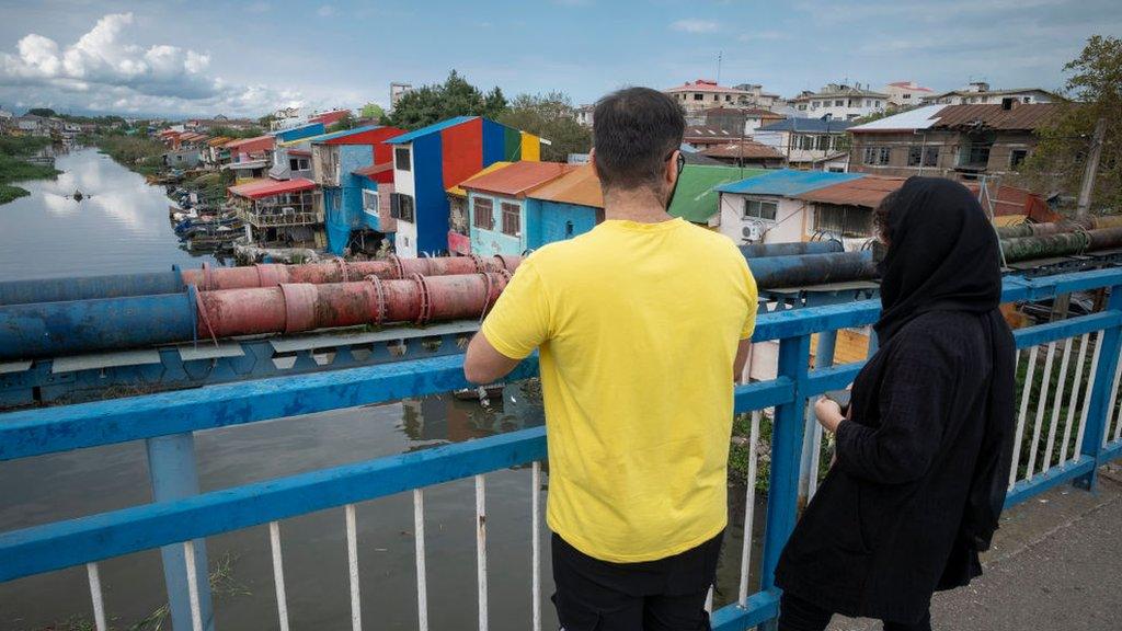 A couple stand on a bridge in Anzali, northern Iran (28 September 2021)