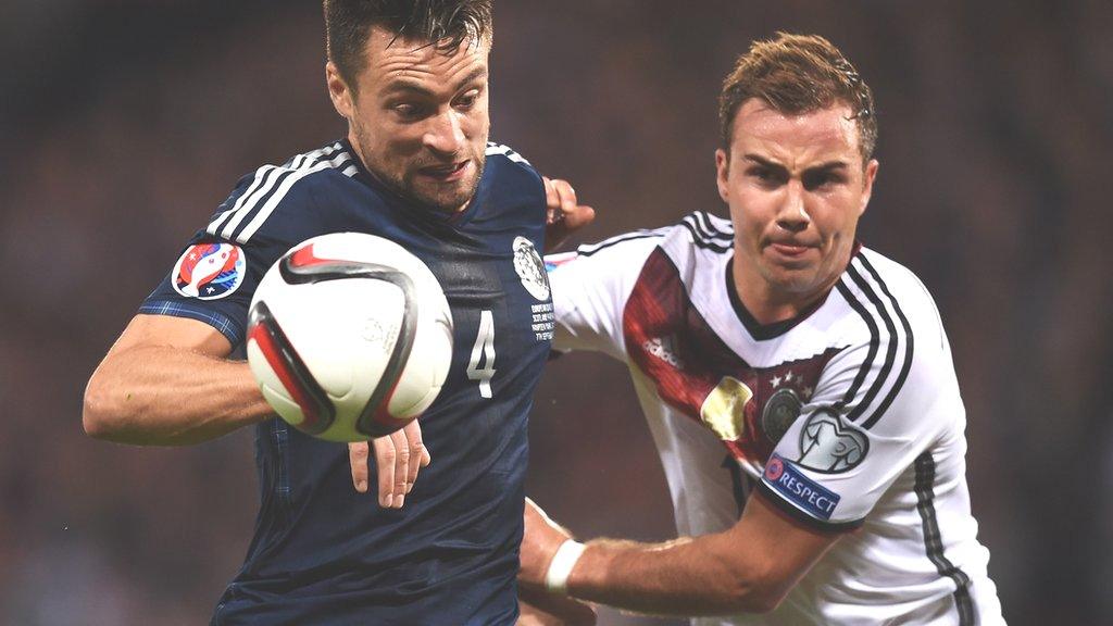 Russell Martin and Mario Gotze challenge for possession