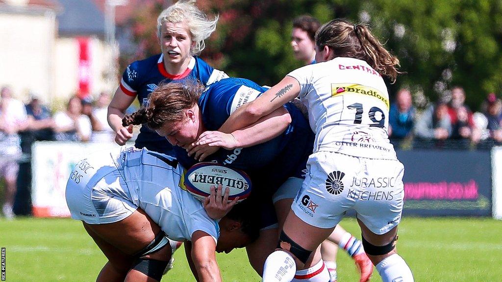 Exeter Chiefs players tackle a Bristol ball carrier