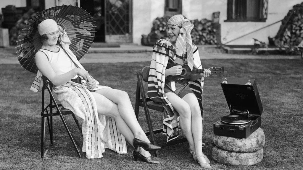 People listen to a phonograph, 1929