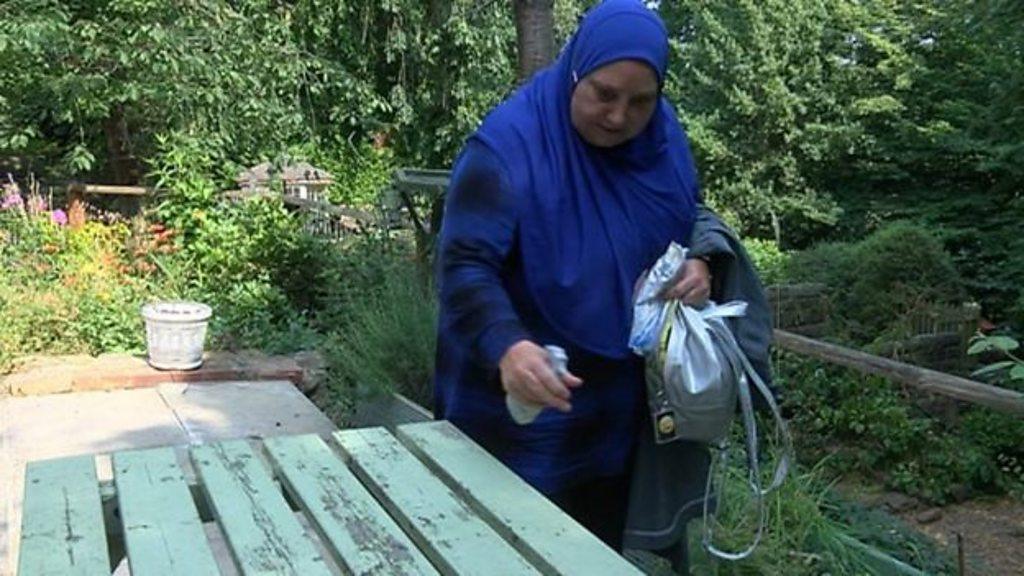 Lynn, who has OCD, cleaning a table