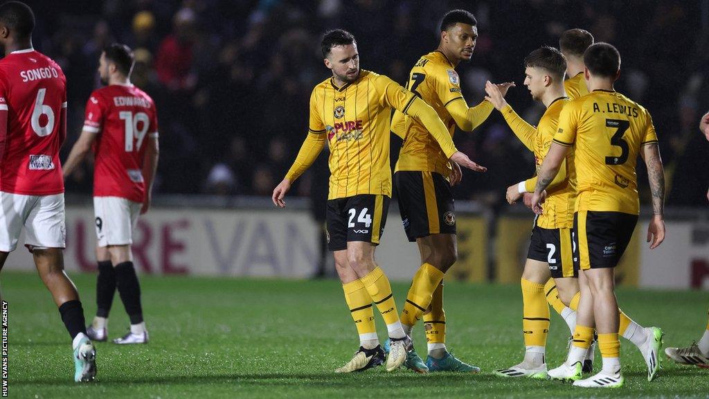 Newport County players celebrate Aaron Wildig's goal against Morecambe