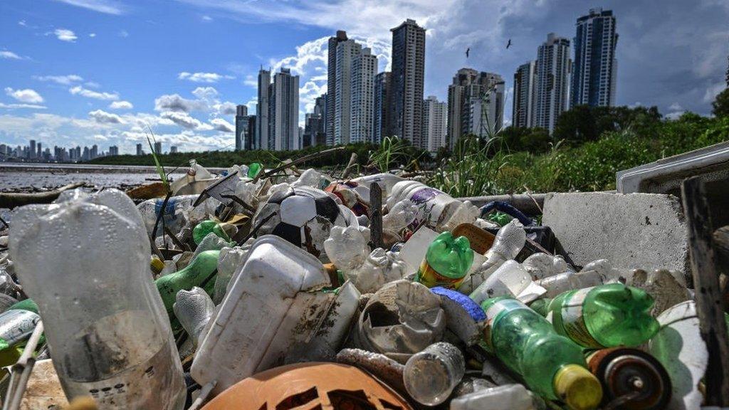 plastic waste with skyscrapers in background