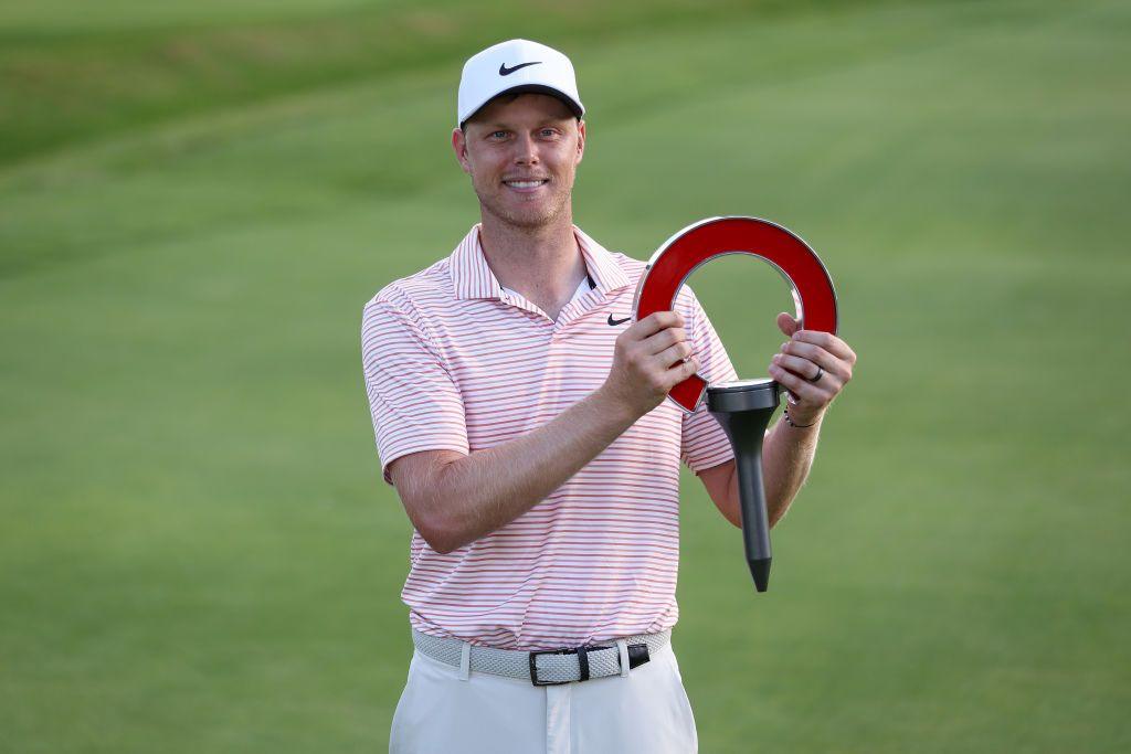 Cameron Davis holds up the trophy for winning the Rocket Mortgage Classic in Detroit