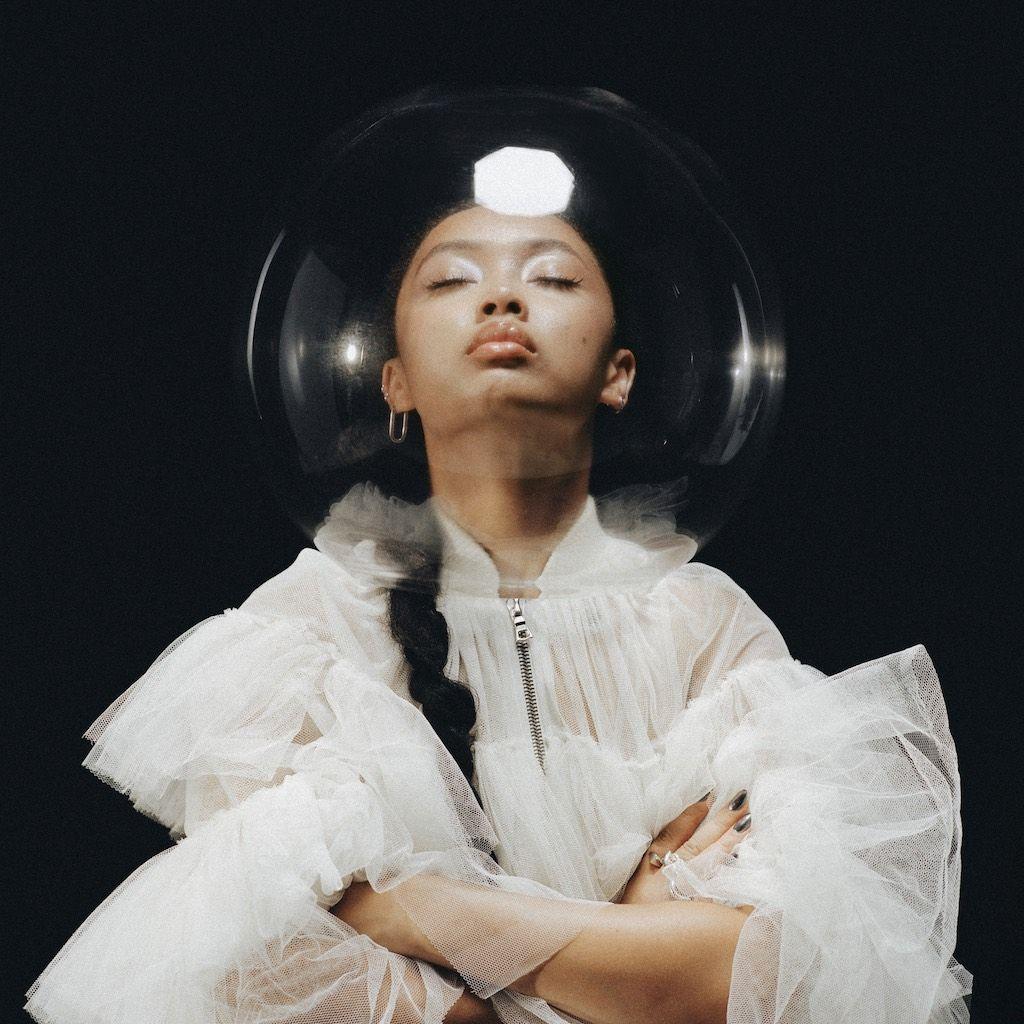 Griff poses in an astronaut's helment as part of a promotional photoshoot for her song Astronaut