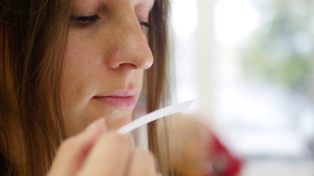 Woman smells perfume