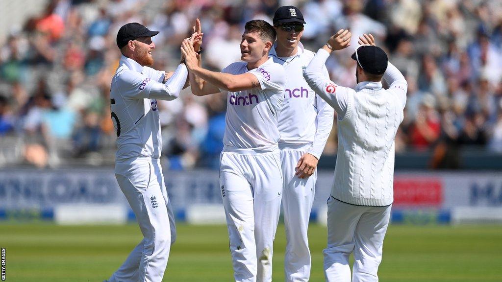 Matthew Potts (middle) celebrates a wicket with Ben Stokes (left) and Zak Crawley (right)