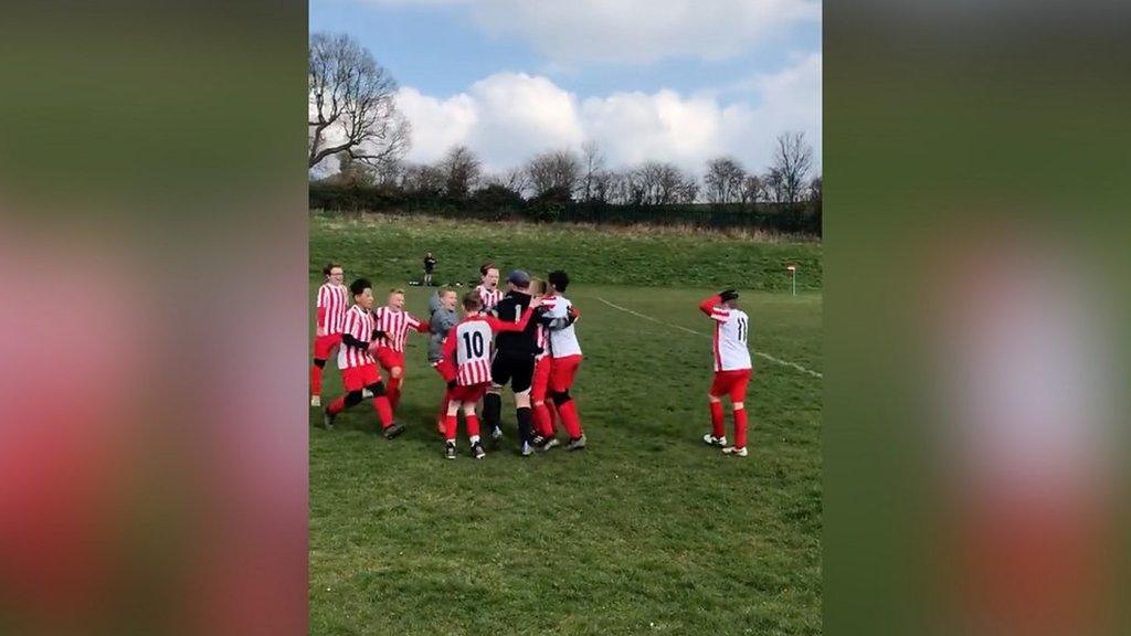 Goalkeeper Charlie Clarke celebrates with his teammates after scoring