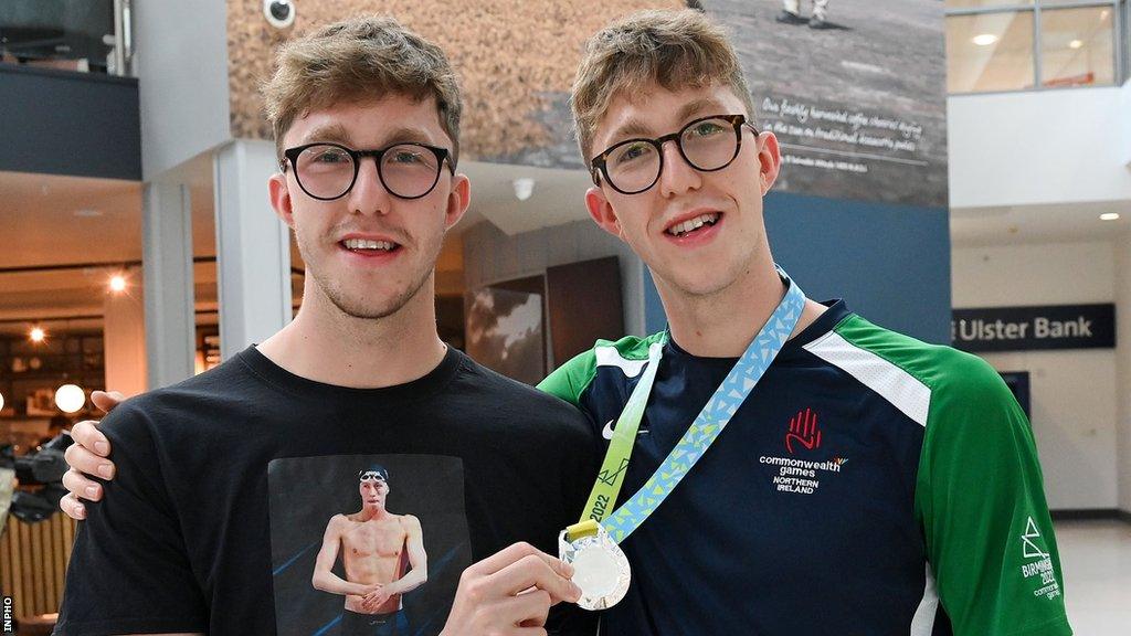 Nathan Wiffen (left) welcomes twin Daniel home after his Commonwealth Games medal-winning performance last year