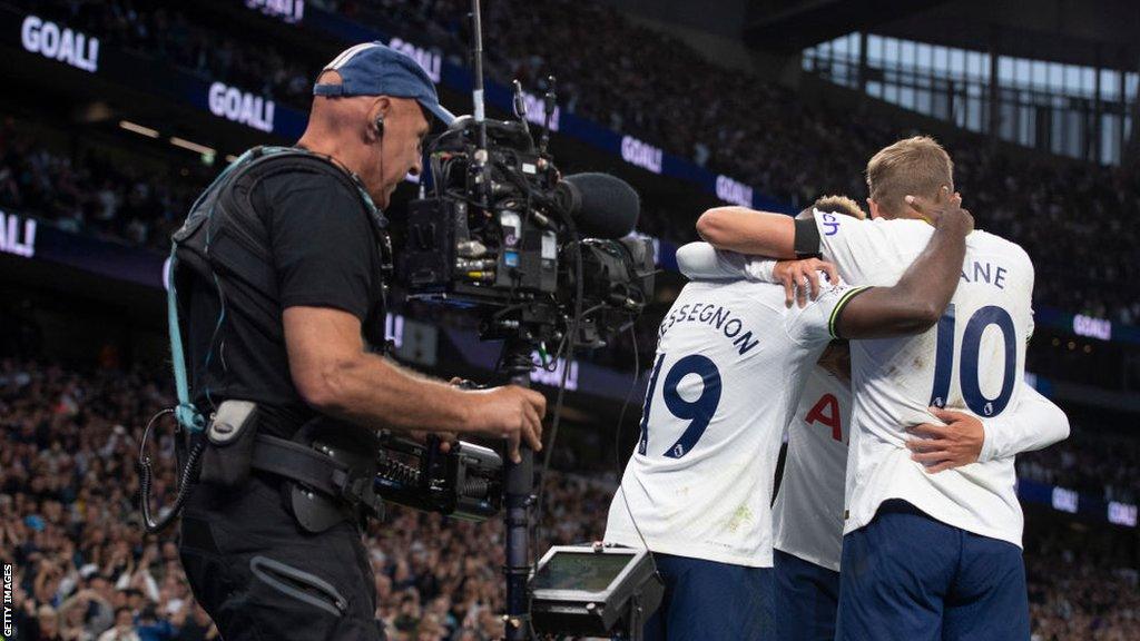 A camera operator films the action at a Premier League game