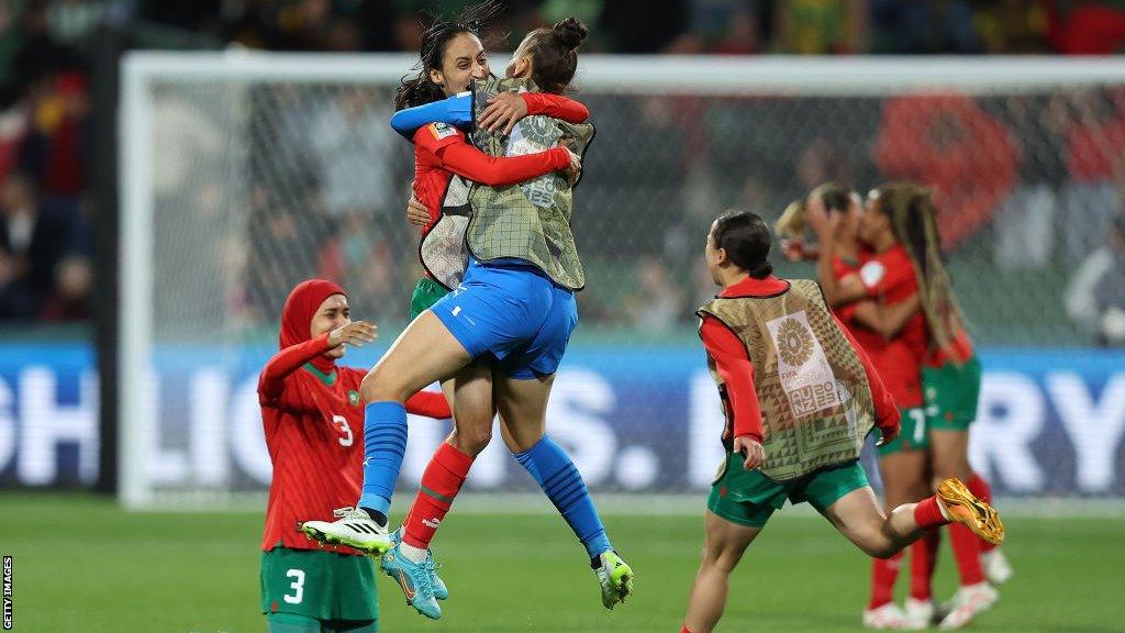 Morocco players celebrate going through to the knockout stages