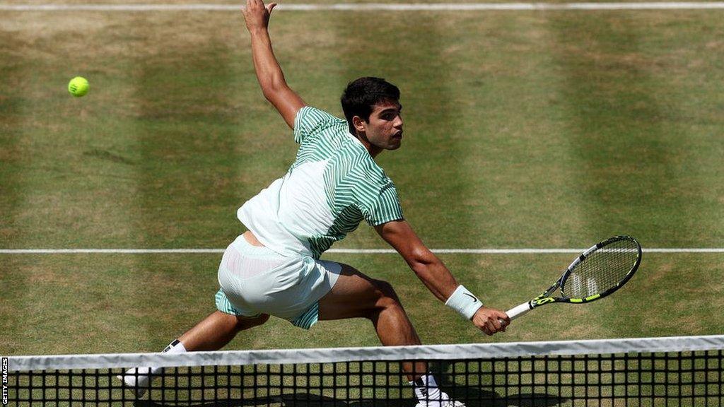 Carlos Alcaraz plays a backhand volley in the Queen's final against Alex de Minaur