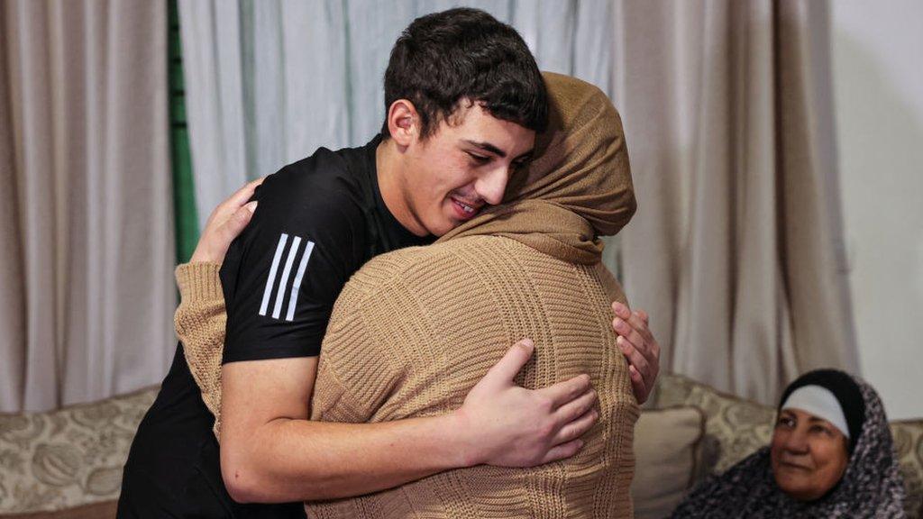 Muhammad Abu Al-Humus, a Palestinian former prisoner released from an Israeli jail, hugs his mother after returning to his home in east Jerusalem