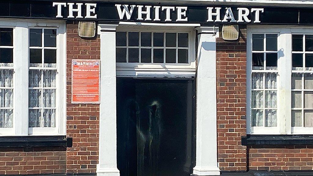 Paint smears on door of White Hart Inn