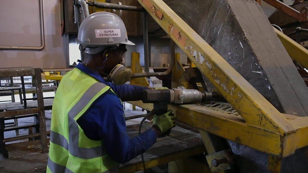 Man in hard hat using a tool