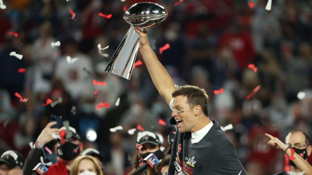 Tom Brady of the Tampa Bay Buccaneers holds the Vince Lombardi Trophy after winning Super Bowl in 2021