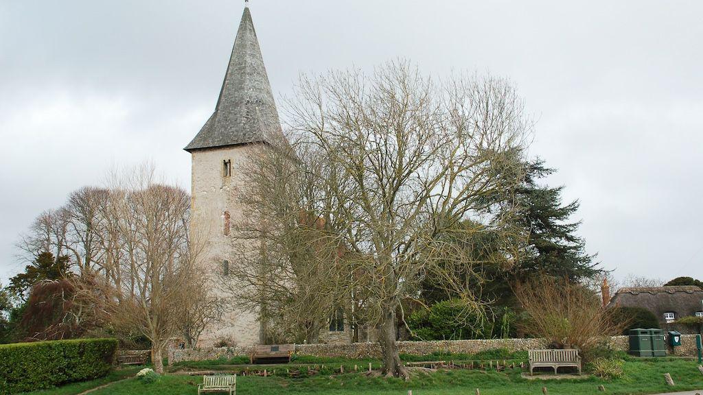 A church with a tree in front of it