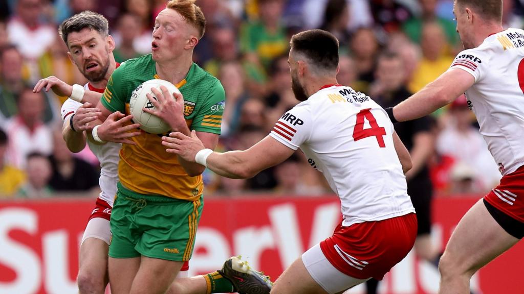 Tyrone's Mattie Donnelly and Padraig Hampsey challenge Donegal's Oisin Gallen