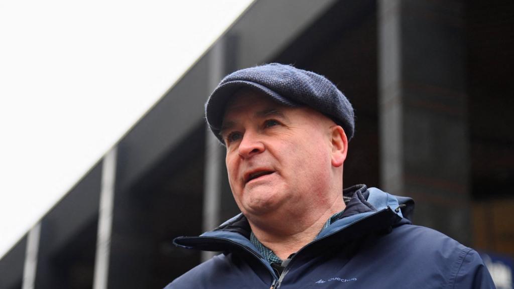 Mick Lynch stands at a picket line