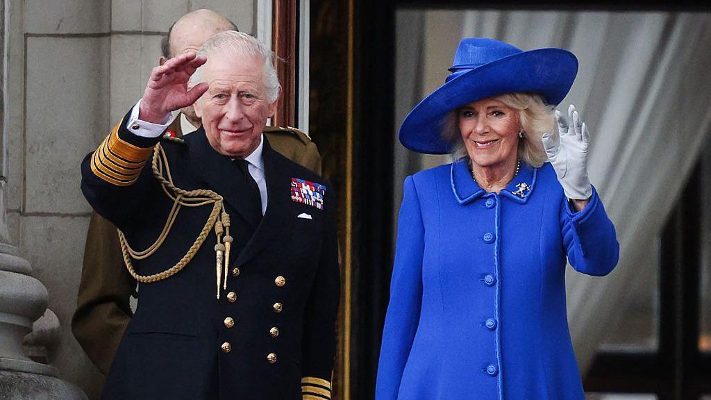 King Charles III and Queen Camilla wave to crowds, on the balcony of Buckingham Palace