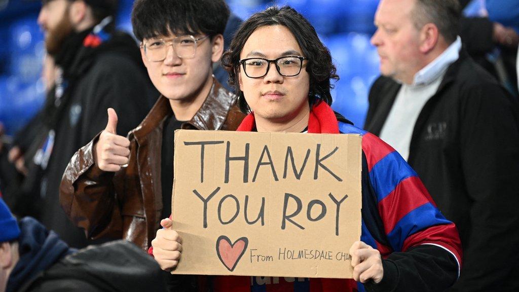 Crystal Palace fans hold up posters thanking Roy Hodgson during their Premier League game at Everton on Monday