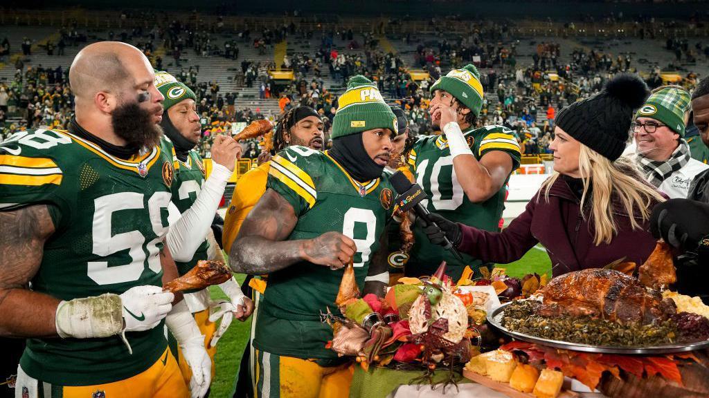 Green Bay Packers players eating turkey following their 2024 Thanksgiving game against the Miami Dolphins