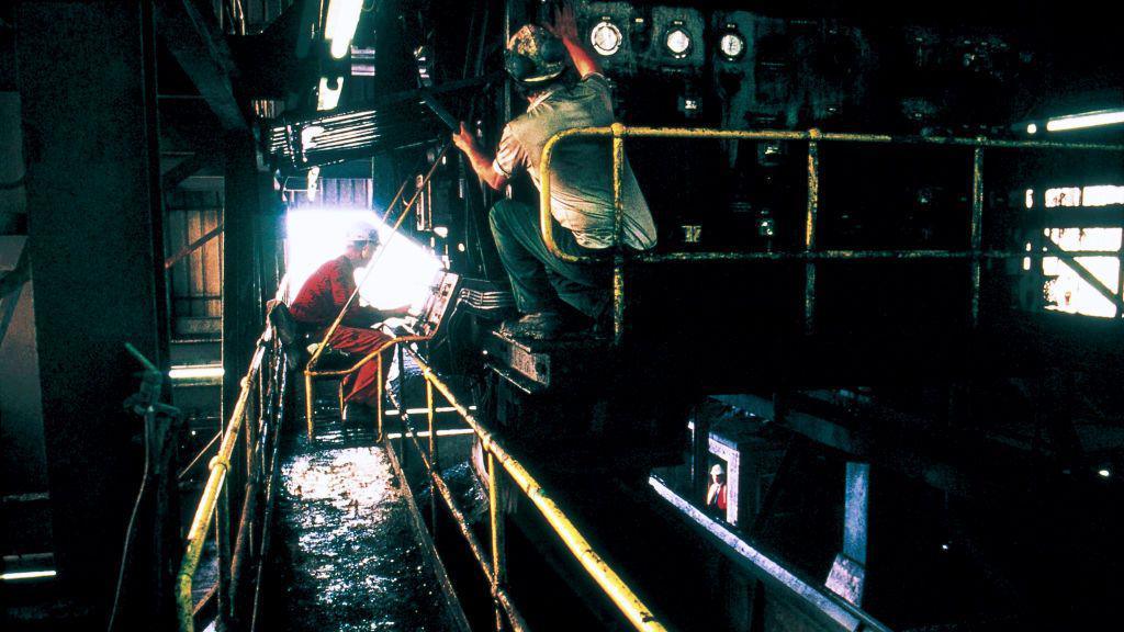 Two men working on machinery inside Shirebrook Colliery in Derbyshire in 1993 months before it closed.