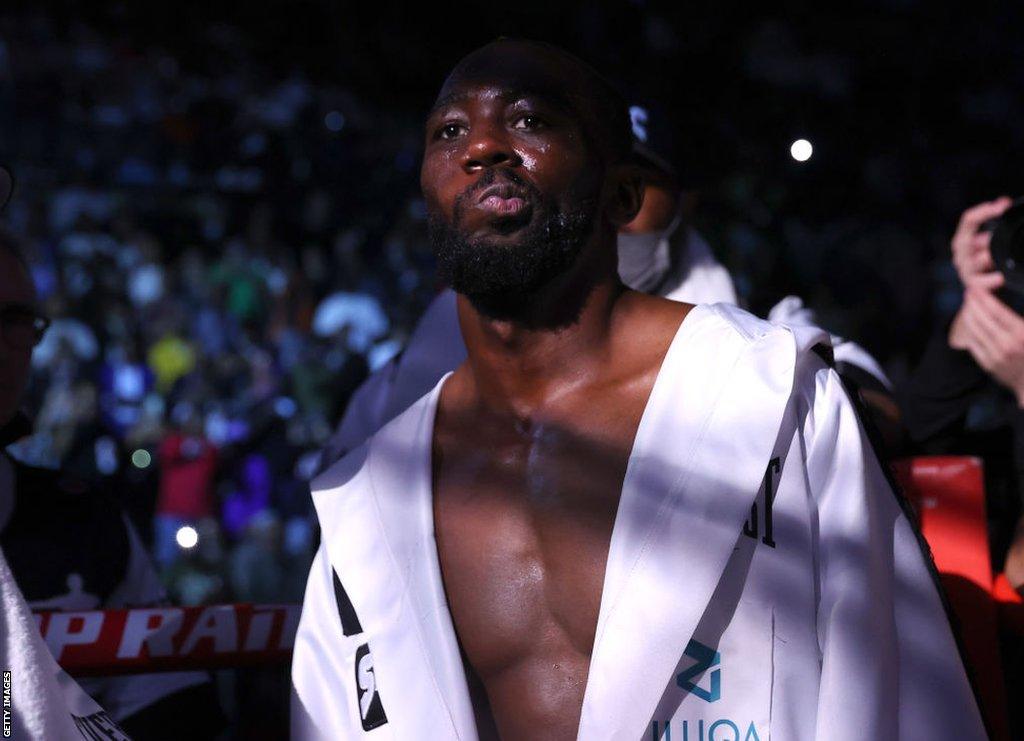 Terence Crawford makes his ring walk in a white robe