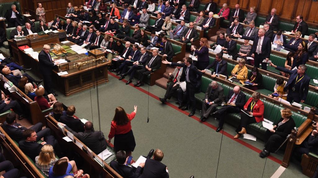 Wide shot of MPs debating in the House of Commons