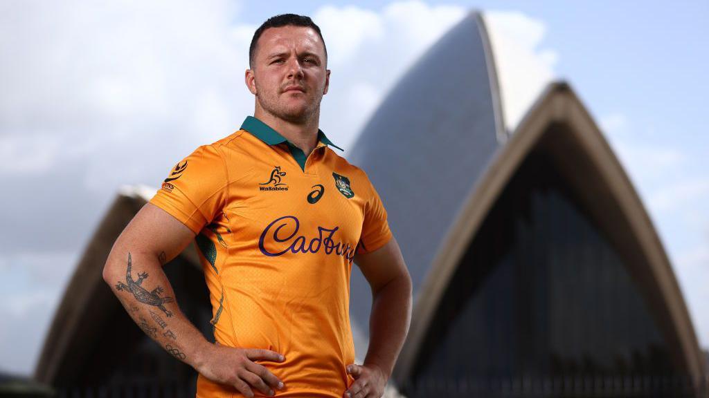 Dylan Pietsch standing in front of Sydney Opera House