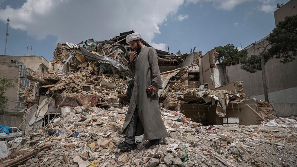 An Iranian cleric walks among the ruins of a synagogue in Tehran, Iran, on April 20, 2026.