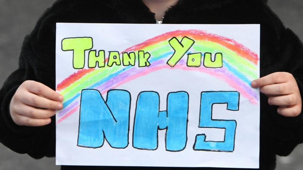 Child holding Thank You NHS sign