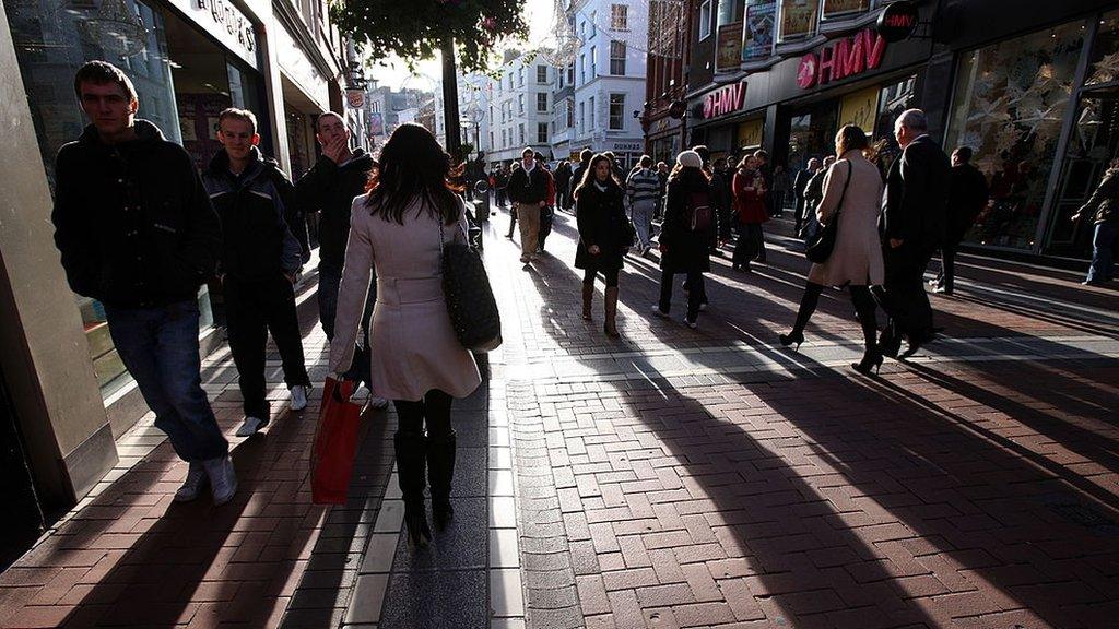 People walk along Grafton Street, the main shopping area of Dublin