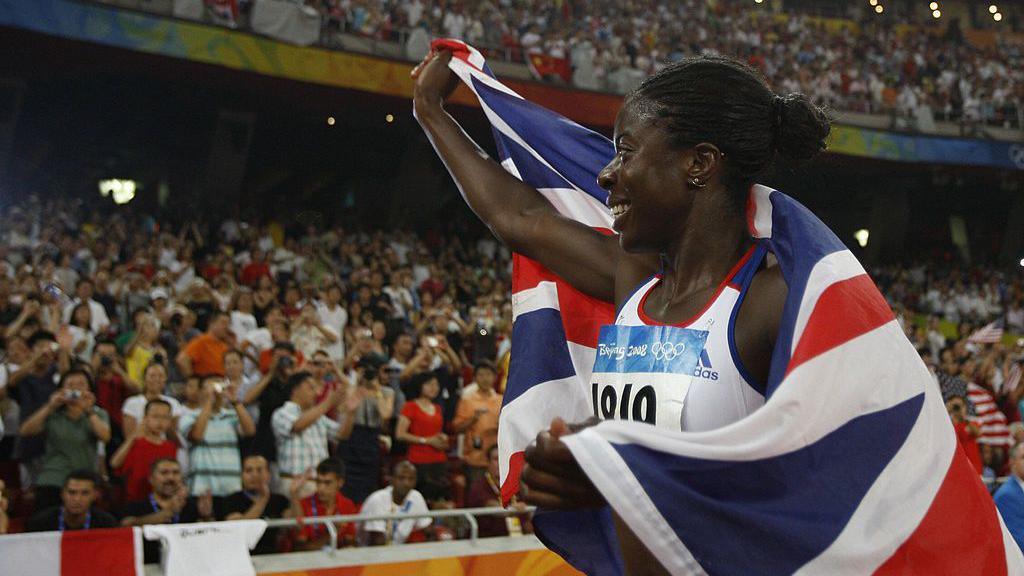 Christine Ohuruogu waves to the crowd after winning 400 metres gold at the Beijing 2008 Olympic Games