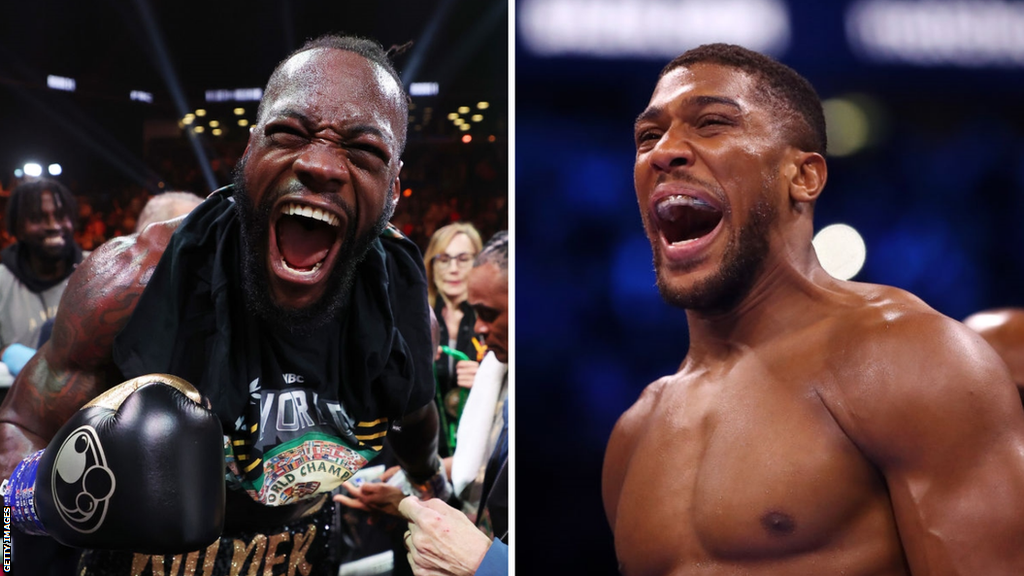 Deontay Wilder celebrates beside a picture of Anthony Joshua celebrating