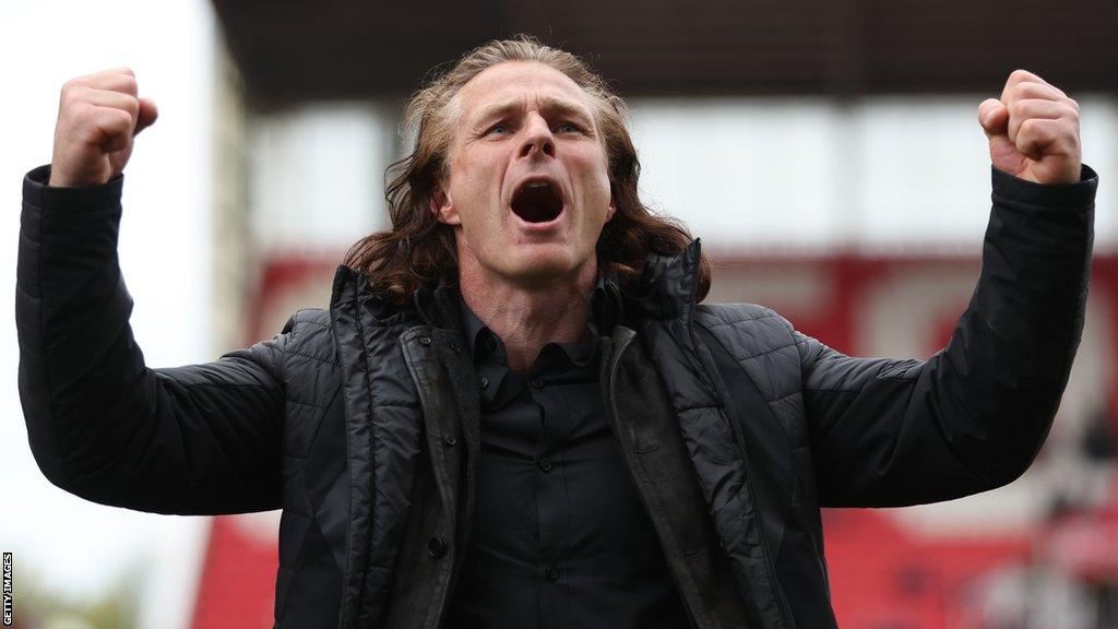 Gareth Ainsworth celebrates towards QPR fans after his side beat Stoke in the Championship