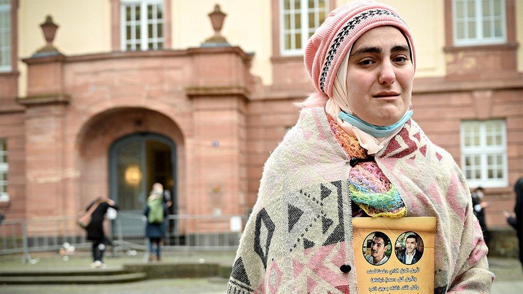 Women protests outside the court where Anwar Raslan is on trial