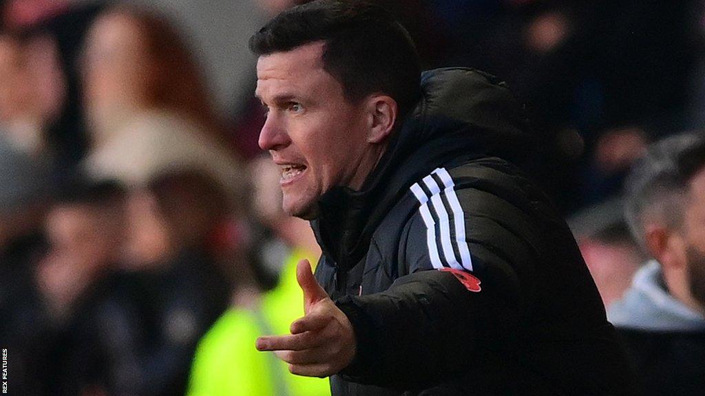 Gary Caldwell watches his Exeter City side lose at Fleetwood Town