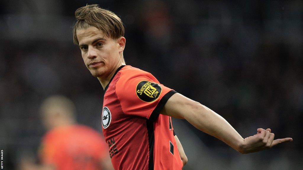 Cameron Peupion points while on the pitch for Brighton against Newcastle last season