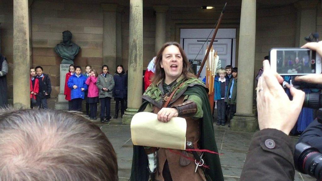 Robin Hood reads from a scroll