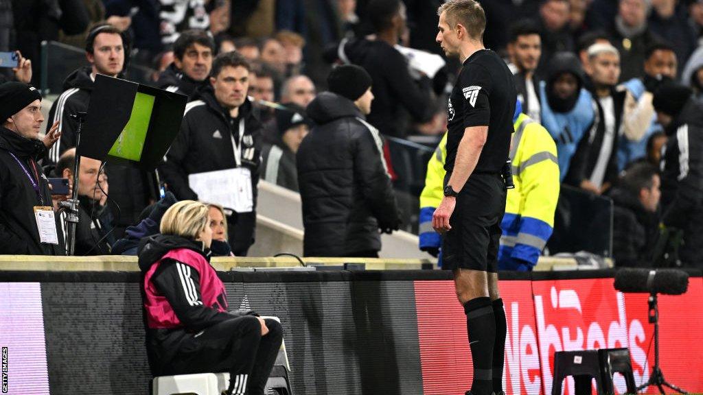 Referee Michael Salisbury overturns his late penalty call after the VAR advised him to look at the pitchside monitor