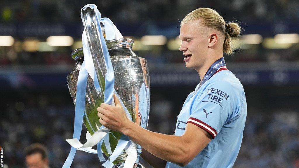 Erling Haaland celebrates with the Champions League trophy after Man City's win against Inter Milan