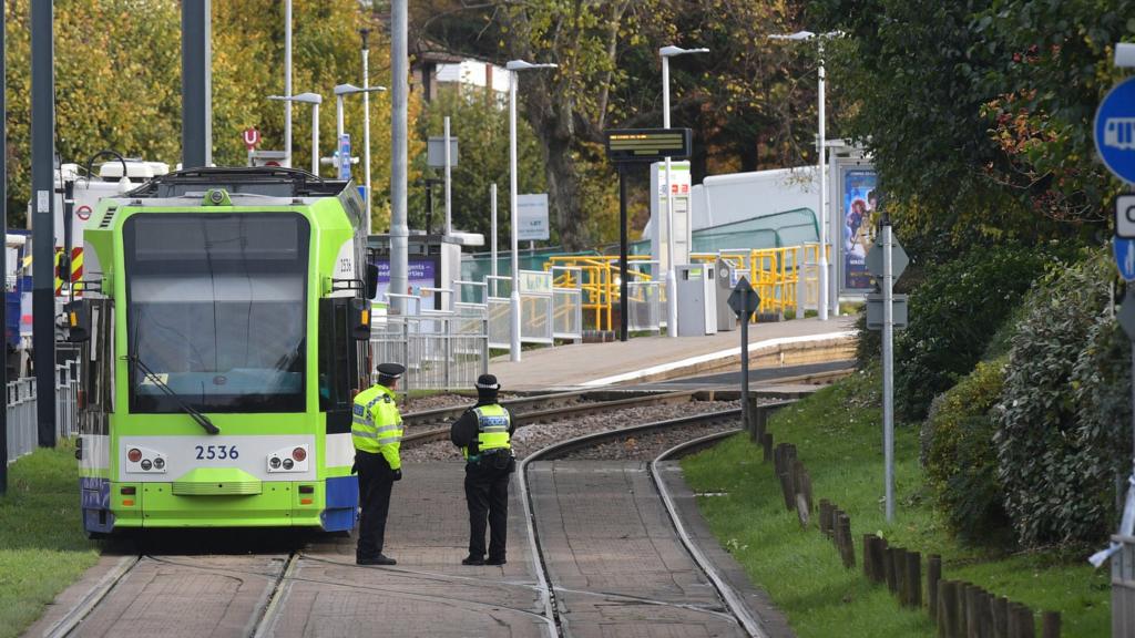 Emergency workers attend the scene of a tram crash