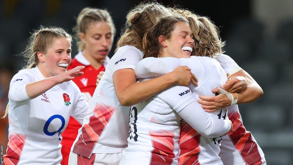 England players celebrate in a huddle